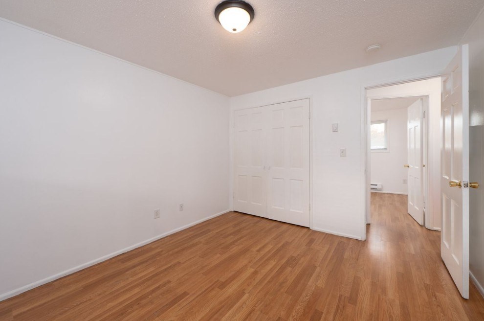 A room with wooden floors and white walls.