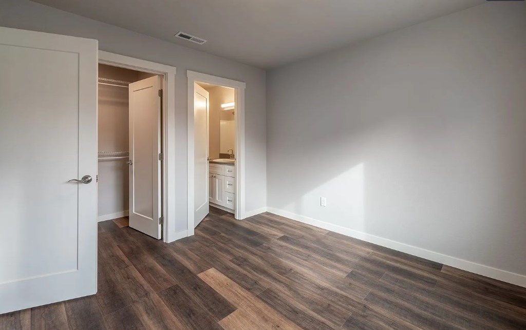 A room with a white door and a white wall.