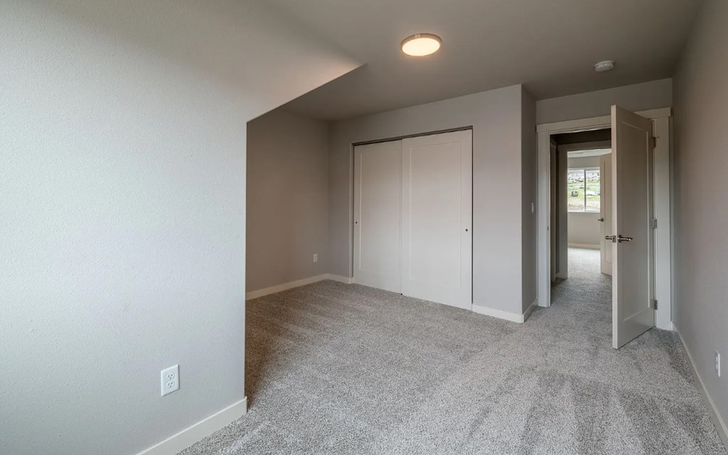 A room with carpeted floor and white walls.
