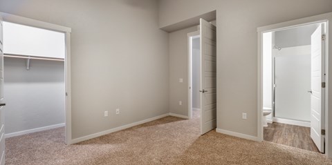 A room with a carpeted floor and white walls.