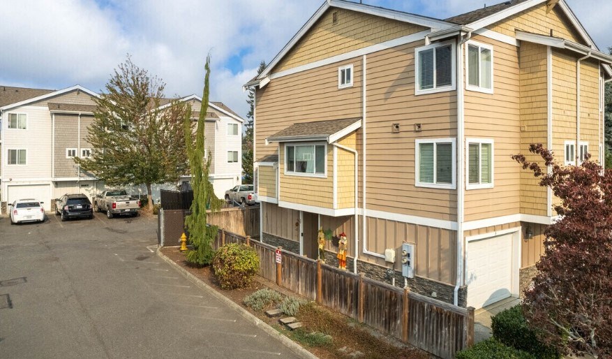 A residential area with apartment buildings and parked cars.