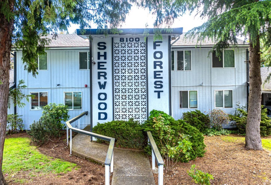 A white building with a sign that says Sherwood Forest.