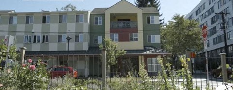 a building with a red car parked in front of it