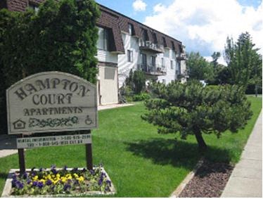 a sign apartments in front of a house