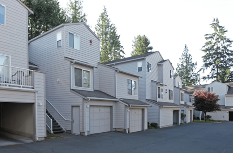 A row of houses with garages in front.