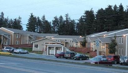 a street with cars parked in front of houses