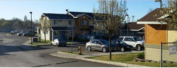 a street with cars parked in front of houses