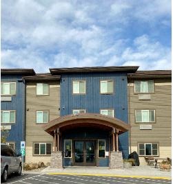the front of a building with a blue sky