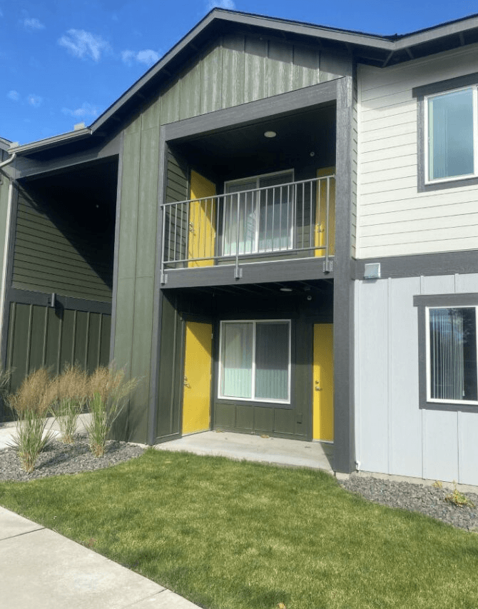 a yellow and with a balcony