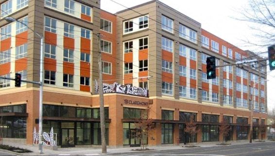 a large building on the corner of a street with a traffic light
