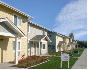a row of houses with a sign in front of them