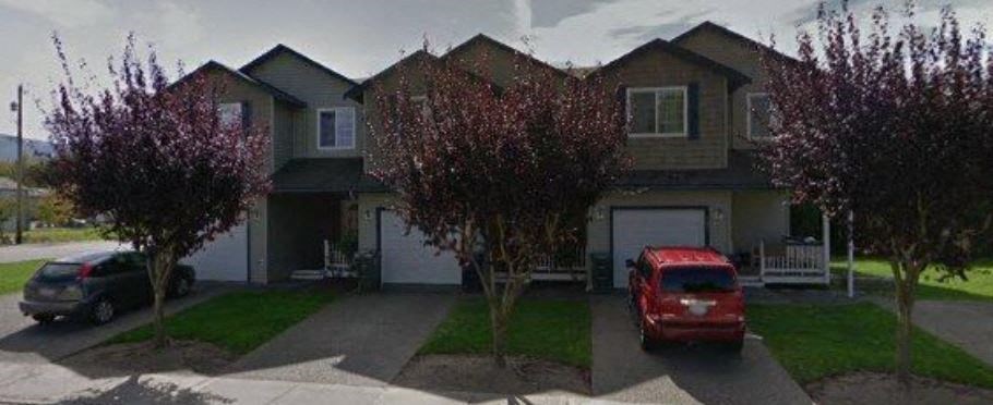 a house with a red car parked in front of it