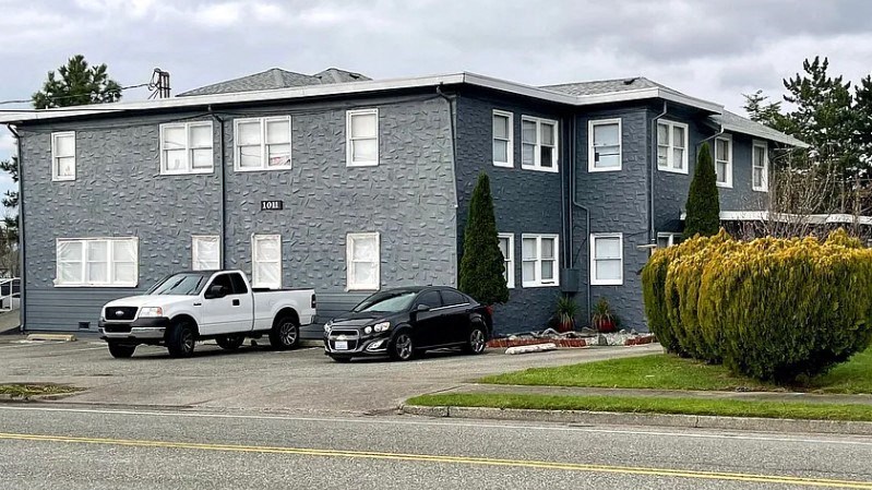a blue building with cars parked in front of it