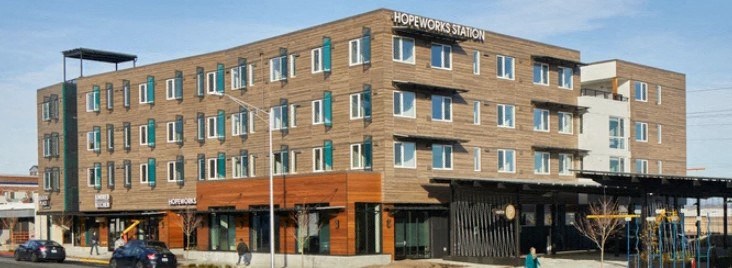 A large building with a sign that says HOPEWORKS STATION on it.