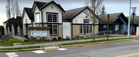 A sign in front of a building that says "Innongon Hill Village".