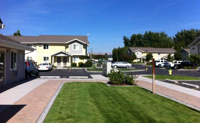 a neighborhood with houses and cars parked on the street