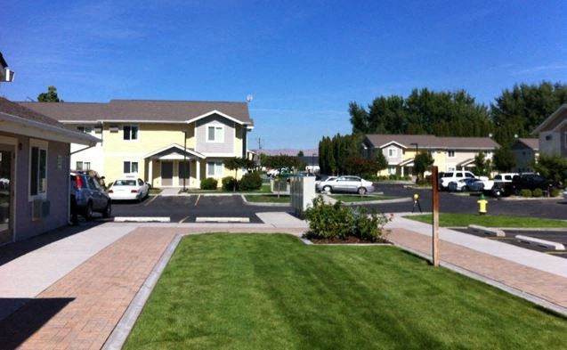 a neighborhood with houses and cars parked on the street