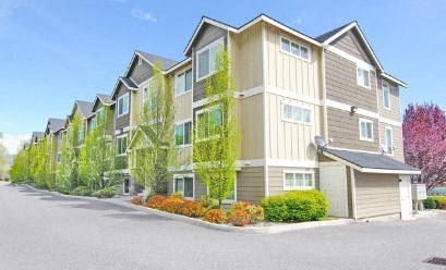 an apartment building with a street in front of it