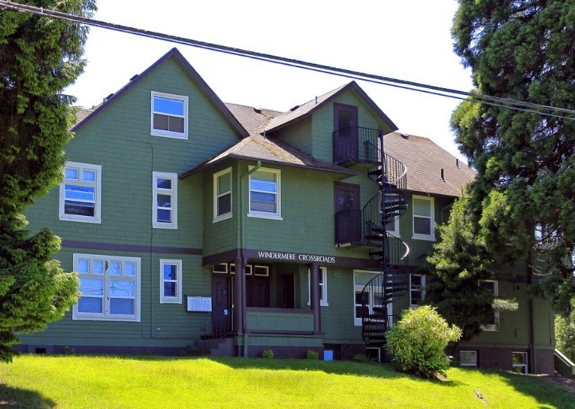 a green house with a yard in front of it