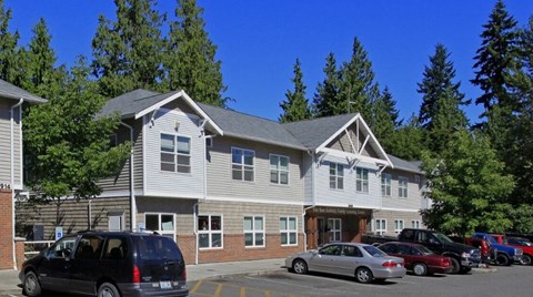 A building with a parking lot in front of it.