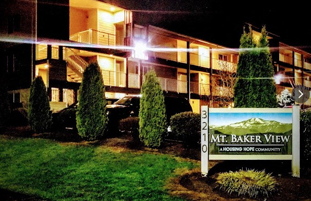 A sign for Mt. Baker View housing community is in front of a building.