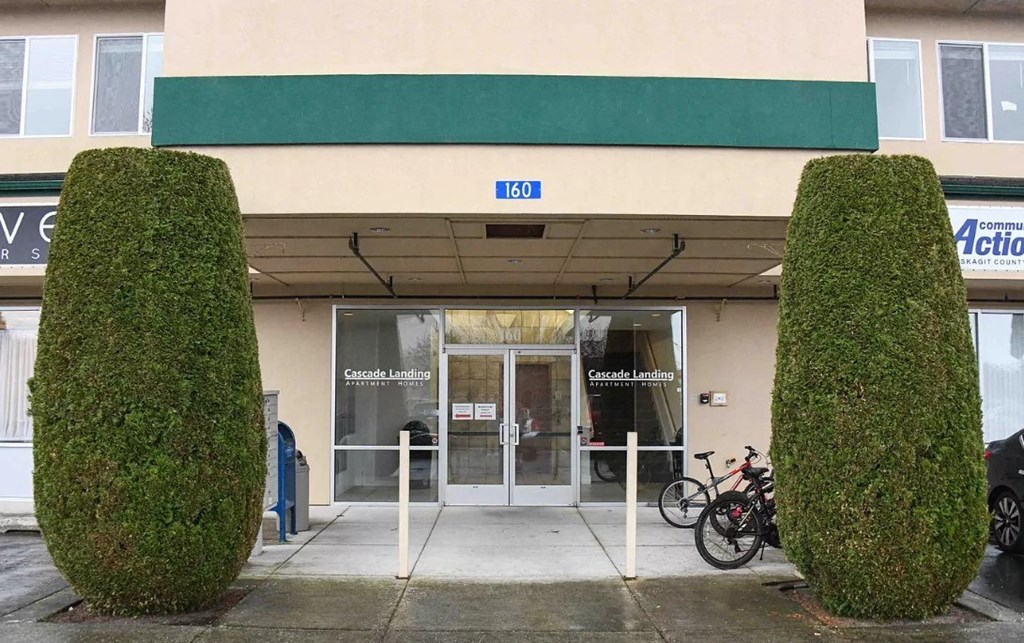 the front door of a building with a bike parked in front of it