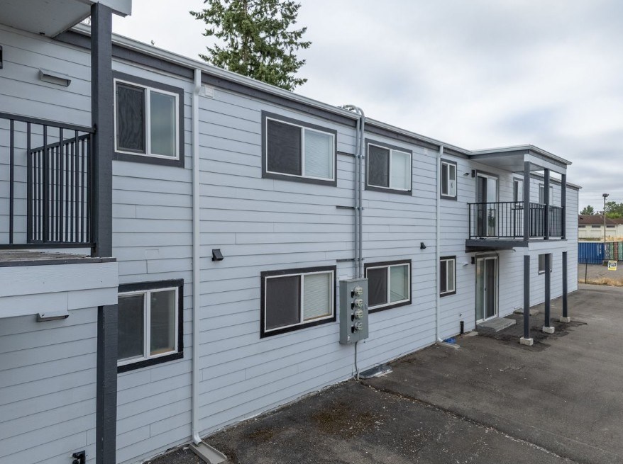 A row of white and grey mobile homes with balconies.