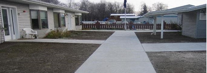 a sidewalk in front of a house