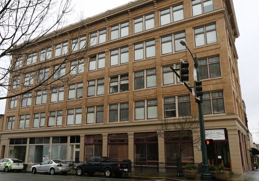 A large building with many windows is in the background.
