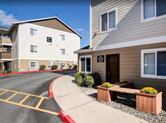 a building with a sidewalk and a street in front of it
