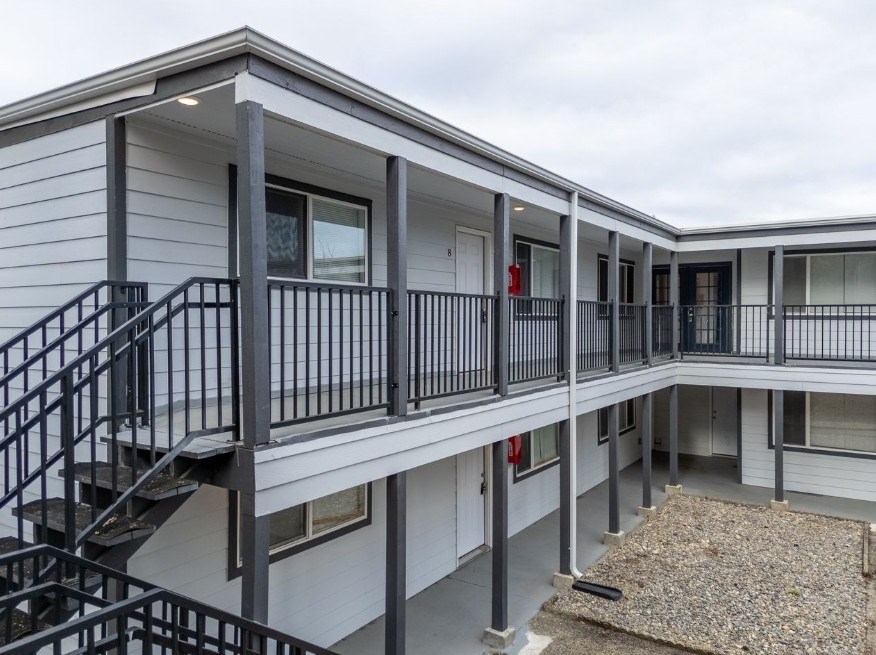 A multi-level residential building with a staircase and railings.