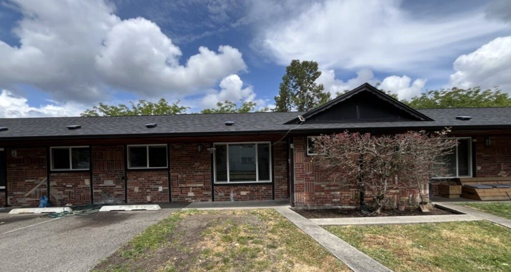 A building with a black roof and brick walls.