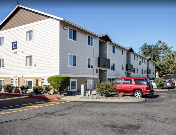 a red van parked in front of an apartment building