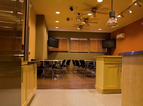 a room with a table and chairs and a refrigerator