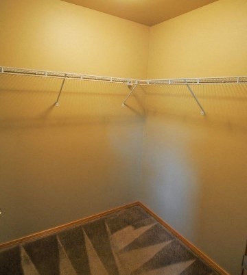 a empty closet with empty shelves in a room