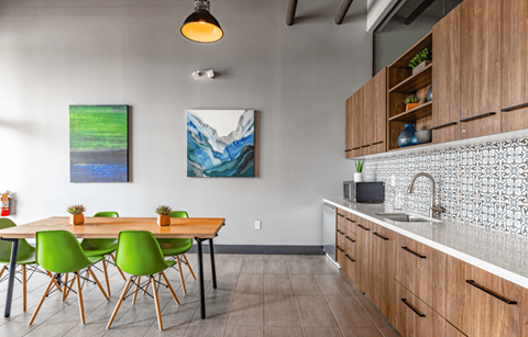 a kitchen and dining area with a table and chairs and a sink
