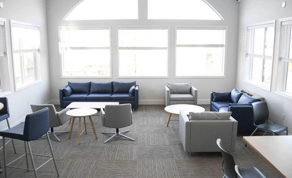 a living room with couches and chairs and tables