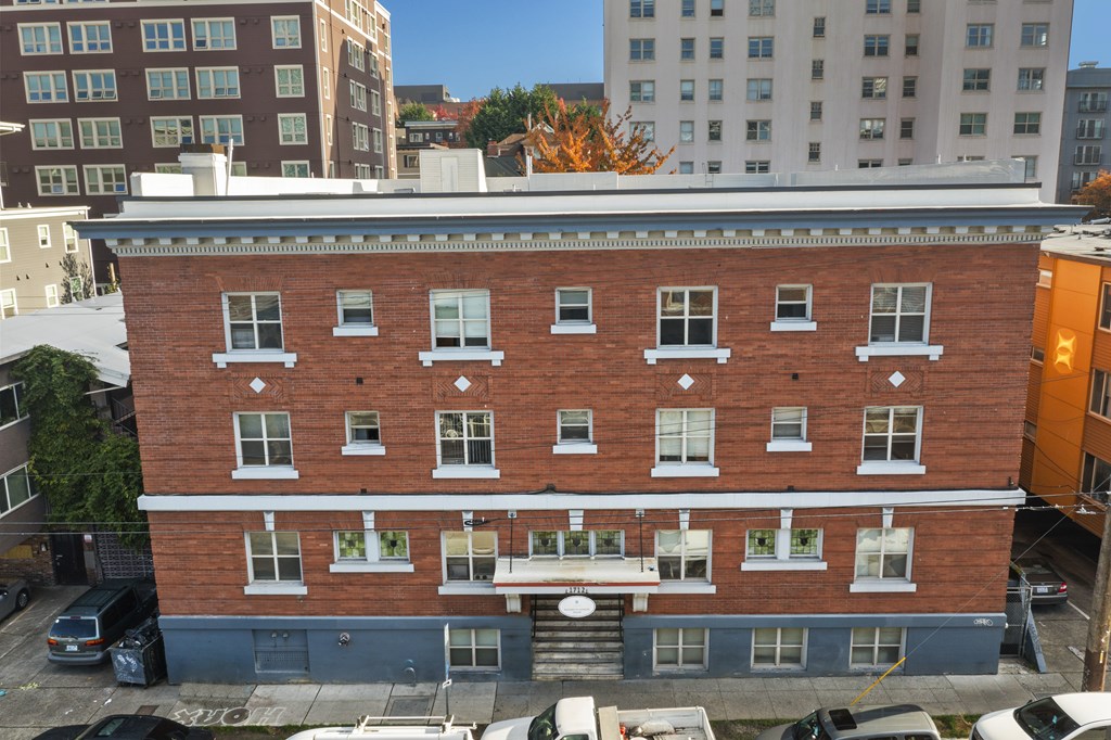 an aerial view of a brick building on a city street
