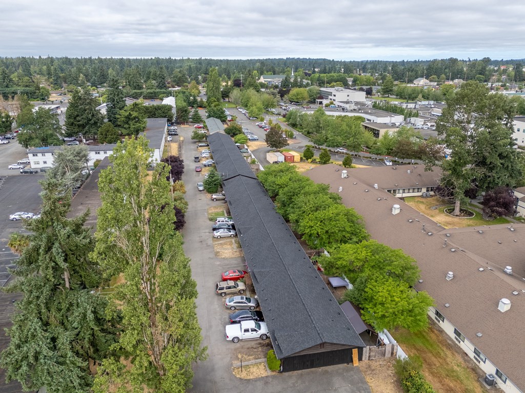 A parking lot with a long building in the middle.