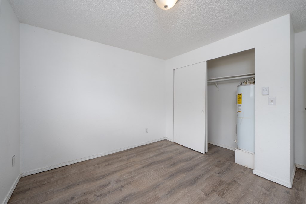 A room with a white door and a white wall.