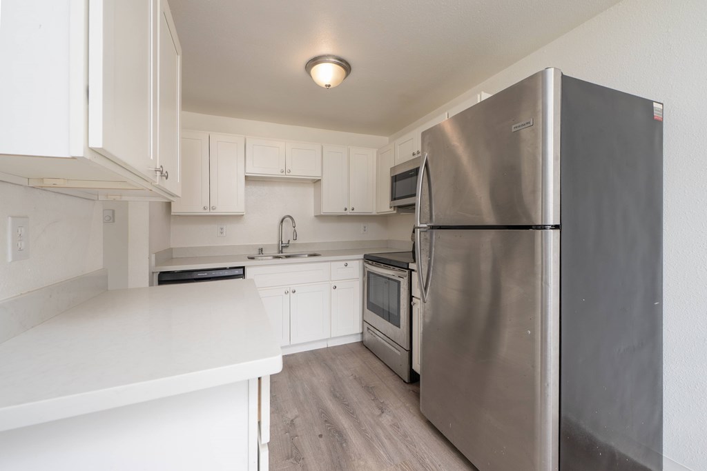 A modern kitchen with a stainless steel refrigerator.