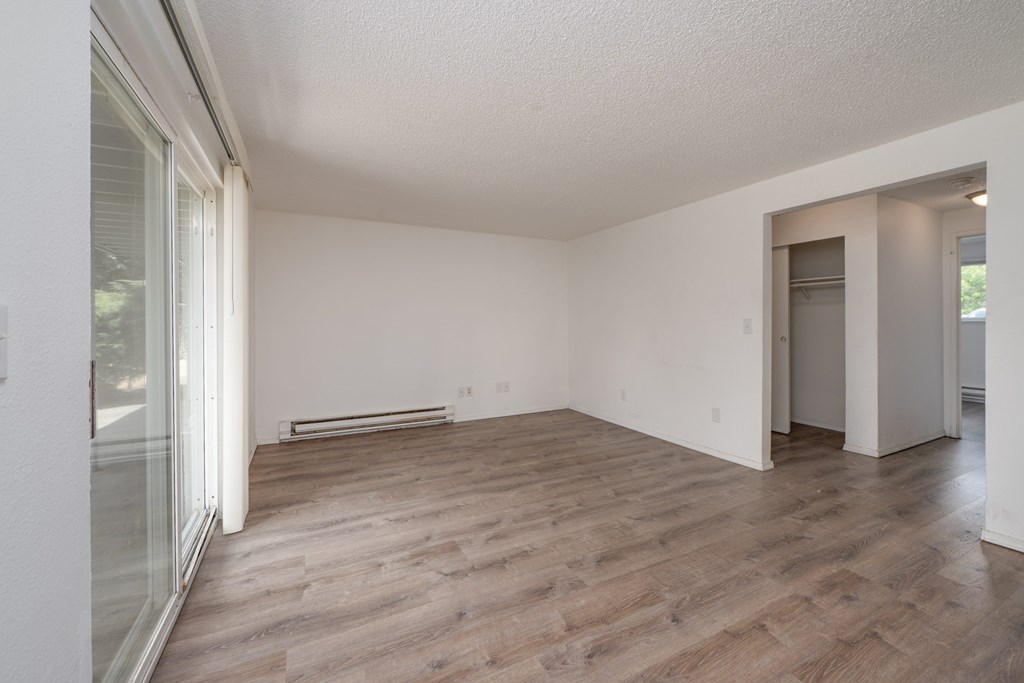 A room with wooden floors and white walls.