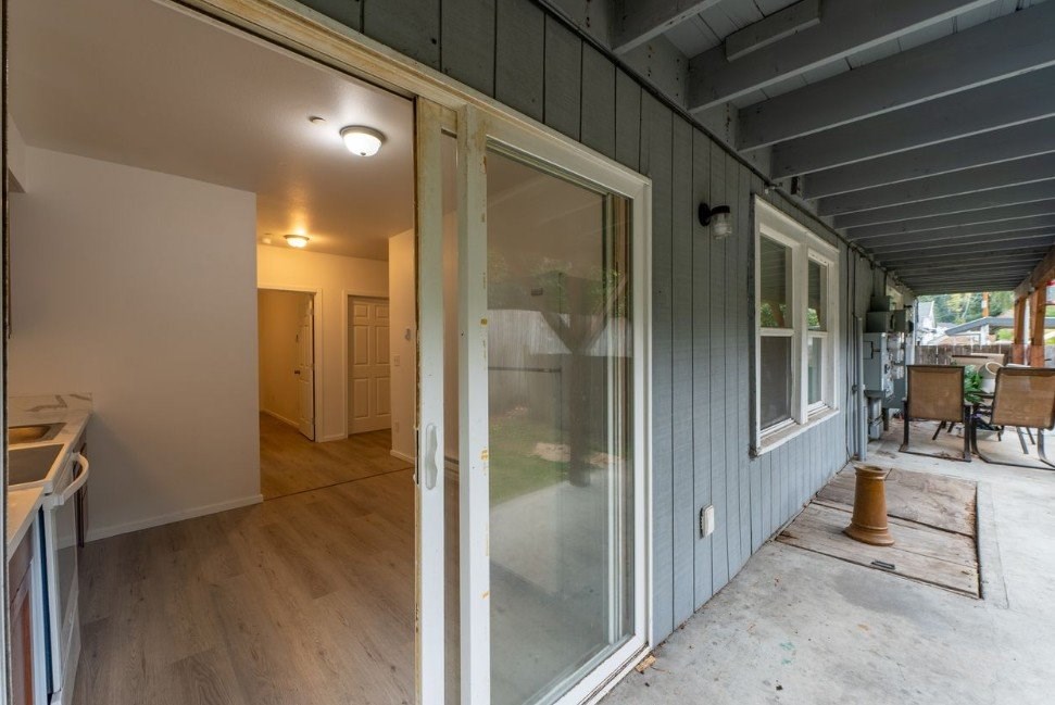 A room with a grey wall and a white door.