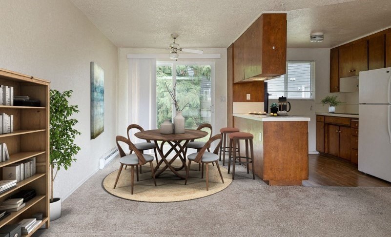 a kitchen and dining room with a table and chairs