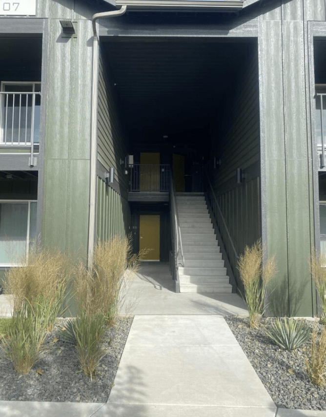 the entrance to an apartment building with stairs