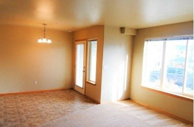 an empty living room with a large window