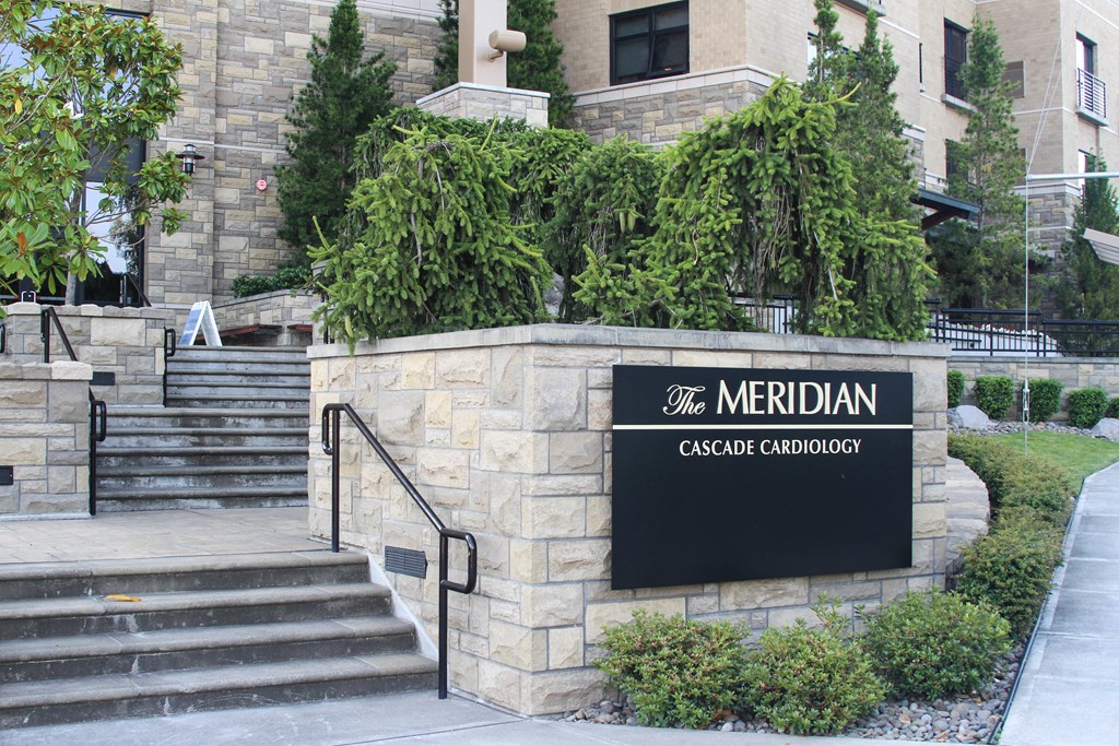 the exterior of the meridian building with stairs and a sign