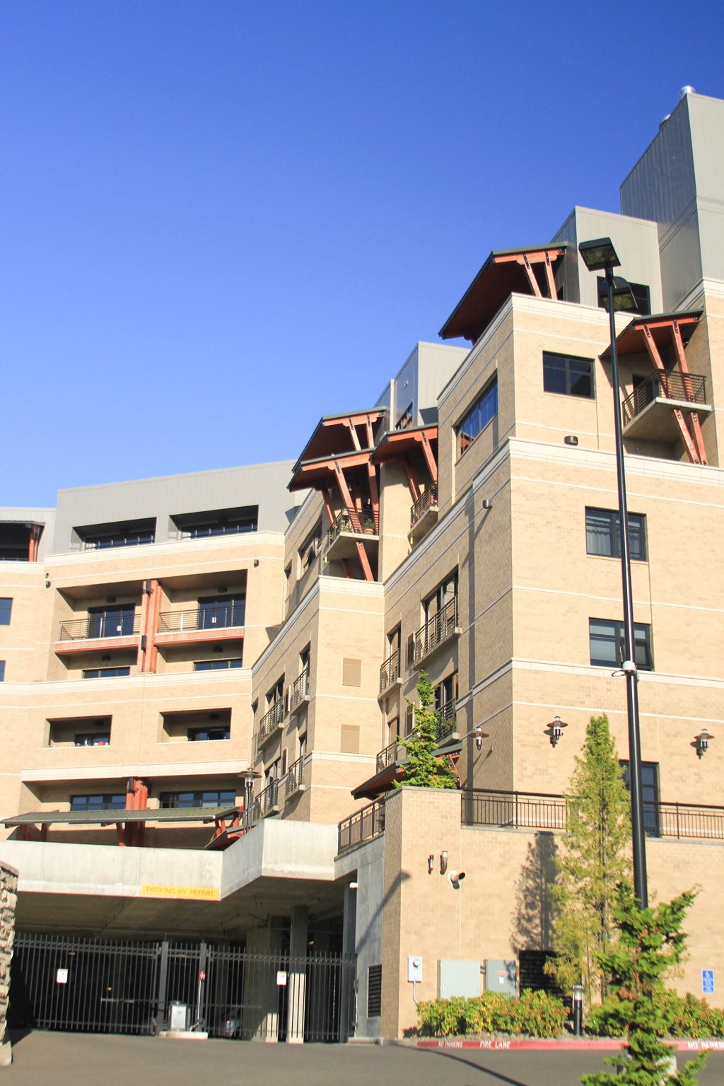 the side of a building with balconies and a street light