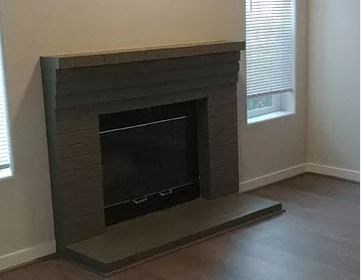 a fireplace in the corner of a living room