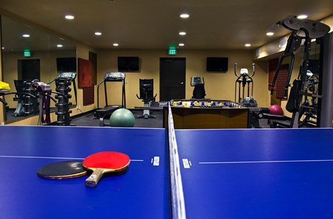 a game of ping pong on a blue table